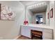 A detailed view of the bathroom vanity area with a large mirror, stool, and decorative lighting at 9602 Sweet Clover Way, Fishers, IN 46038