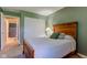 Cozy bedroom view with a wooden bed frame and view to hall with bathroom at 9602 Sweet Clover Way, Fishers, IN 46038