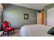 Bedroom showcasing wooden furniture, green walls, chair and view to door at 9602 Sweet Clover Way, Fishers, IN 46038