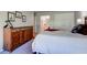 A well-appointed bedroom showcasing a dresser, closet, and a glimpse into the adjoining bathroom at 9602 Sweet Clover Way, Fishers, IN 46038
