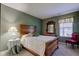 A charming bedroom showcasing a wooden bed frame, vintage dresser, and a quaint chair at 9602 Sweet Clover Way, Fishers, IN 46038