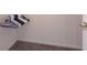 An empty walk-in closet with neutral carpeting, white baseboards and wire shelving at 9602 Sweet Clover Way, Fishers, IN 46038