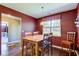 This dining room offers hardwood floors, a wooden table, and abundant natural light at 9602 Sweet Clover Way, Fishers, IN 46038
