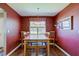 The dining room features hardwood floors, a wooden table, and natural light at 9602 Sweet Clover Way, Fishers, IN 46038