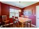 The dining room features hardwood floors, a wooden table, and natural light at 9602 Sweet Clover Way, Fishers, IN 46038
