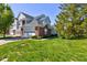Exterior view of a well-manicured lawn and a two-story home with an attached garage at 9602 Sweet Clover Way, Fishers, IN 46038