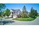 View of the lovely townhouse with a well-manicured lawn, mature trees, and a convenient two-car garage at 9602 Sweet Clover Way, Fishers, IN 46038