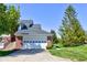Spacious two-car garage with a white door and well-maintained landscaping at 9602 Sweet Clover Way, Fishers, IN 46038