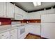White kitchen cabinets and appliances, providing a clean and functional space for cooking and entertaining at 9602 Sweet Clover Way, Fishers, IN 46038