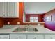 Functional kitchen with stainless steel double sink and a view to the adjoining living area at 9602 Sweet Clover Way, Fishers, IN 46038