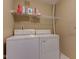 Laundry room complete with a washer, dryer and a shelf for convenient storage at 9602 Sweet Clover Way, Fishers, IN 46038