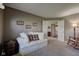The living room features neutral walls, a white couch, and carpet floors at 9602 Sweet Clover Way, Fishers, IN 46038