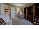 The living room features a rocker, neutral walls, carpet floors, and bookshelves at 9602 Sweet Clover Way, Fishers, IN 46038