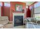 Cozy fireplace with decor, comfortable seating, and ample light from large windows, perfect for relaxing evenings at 9602 Sweet Clover Way, Fishers, IN 46038