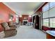 Spacious living room featuring a fireplace, neutral carpet, and large windows allowing ample natural light at 9602 Sweet Clover Way, Fishers, IN 46038