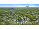Aerial view showing the property's location within a neighborhood near parks, a shopping center, and wooded areas at 9656 Loganberry Ln, Indianapolis, IN 46256