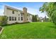 Expansive backyard showcasing well-maintained lawn, mature trees, and an outdoor dining area at 9656 Loganberry Ln, Indianapolis, IN 46256