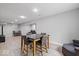 Finished basement area with gray walls and light wood flooring, featuring a dining table and living space at 9656 Loganberry Ln, Indianapolis, IN 46256