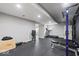 A fully equipped basement gym featuring a treadmill and weight-lifting equipment at 9656 Loganberry Ln, Indianapolis, IN 46256
