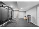 This basement gym features a squat rack and weight bench set against a dark gray accent wall at 9656 Loganberry Ln, Indianapolis, IN 46256