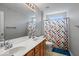 Bathroom features a double sink vanity, large mirror, and a shower/tub combo with colorful curtain at 9656 Loganberry Ln, Indianapolis, IN 46256