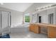 An elegant bathroom with a soaking tub, glass shower, and natural wood vanity at 9656 Loganberry Ln, Indianapolis, IN 46256