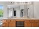 Bright bathroom featuring a large mirror, double sinks, and white countertops at 9656 Loganberry Ln, Indianapolis, IN 46256