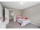 Cozy bedroom featuring carpet floors, floral wallpaper, a twin bed, and ample natural light at 9656 Loganberry Ln, Indianapolis, IN 46256