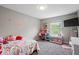 Charming bedroom with a TV and desk features cute rose decals on the gray walls at 9656 Loganberry Ln, Indianapolis, IN 46256