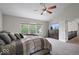 Bedroom featuring neutral walls, plush carpeting, a ceiling fan, and multiple windows at 9656 Loganberry Ln, Indianapolis, IN 46256