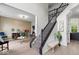 Elegant foyer with staircase, bench, and access to living room at 9656 Loganberry Ln, Indianapolis, IN 46256