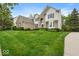 Inviting two-story home with brick and siding, complemented by lush green lawn at 9656 Loganberry Ln, Indianapolis, IN 46256