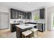 Stylish kitchen with dark cabinetry, stainless steel appliances, and island seating at 9656 Loganberry Ln, Indianapolis, IN 46256