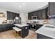 A spacious kitchen with a center island, stainless steel appliances, and dark cabinets at 9656 Loganberry Ln, Indianapolis, IN 46256