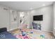 Bright living room featuring modern flooring, grey walls, and vibrant, colorful hand-print rug at 9656 Loganberry Ln, Indianapolis, IN 46256