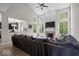 Bright living room with fireplace, large windows, and view into open kitchen at 9656 Loganberry Ln, Indianapolis, IN 46256