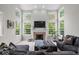Spacious living room with a fireplace, large windows, and a vaulted ceiling at 9656 Loganberry Ln, Indianapolis, IN 46256