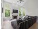 Bright living room with large windows, a fireplace, and a comfortable seating area at 9656 Loganberry Ln, Indianapolis, IN 46256
