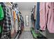 A fully stocked walk-in closet featuring hanging clothes and storage at 9656 Loganberry Ln, Indianapolis, IN 46256