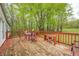 Back deck of house with outdoor furniture, greenery, and rustic wood planks at 9660 Old Haggard Rd, Morgantown, IN 46160