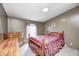 Comfortable bedroom with a wooden bed frame, natural light, and neutral-toned walls at 9660 Old Haggard Rd, Morgantown, IN 46160