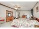 Spacious bedroom featuring a ceiling fan, wooden trim, and abundant natural light at 9660 Old Haggard Rd, Morgantown, IN 46160