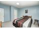 Bedroom with light blue walls, comfortable bed, and plenty of natural light at 9660 Old Haggard Rd, Morgantown, IN 46160