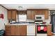 Functional kitchen featuring wood cabinets, modern appliances, and laminate countertops at 9660 Old Haggard Rd, Morgantown, IN 46160