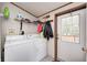 A laundry room featuring a washer and dryer, shelving, and an exterior door to the backyard at 9660 Old Haggard Rd, Morgantown, IN 46160
