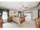 Spacious main bedroom with carpeted floors, a ceiling fan, and a large walk-in closet at 9660 Old Haggard Rd, Morgantown, IN 46160