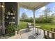 Relaxing outdoor porch with patio furniture, lush greenery, string lights, and a view of the lawn at 9696 Parkhurst Xing, McCordsville, IN 46055