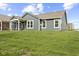Backyard featuring a covered patio, expansive green lawn, and a home with gray siding at 9696 Parkhurst Xing, McCordsville, IN 46055