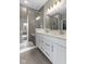 Stylish bathroom boasts a glass-enclosed shower, dual sinks, and elegant finishes, offering a spa-like experience at 9696 Parkhurst Xing, McCordsville, IN 46055