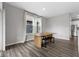 Bright dining area features a rustic wood table and bench, complemented by large windows offering natural light at 9696 Parkhurst Xing, McCordsville, IN 46055
